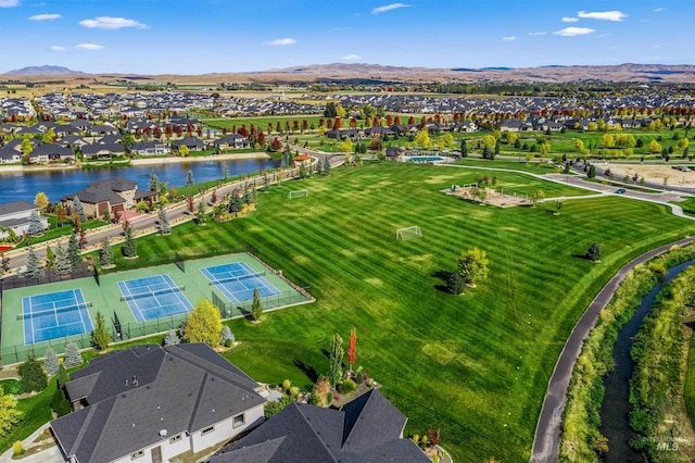 drone / aerial view with a water and mountain view