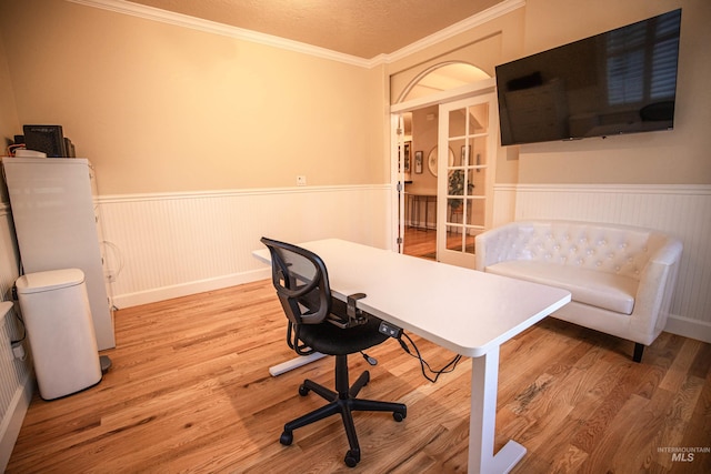 office space featuring wood-type flooring and crown molding