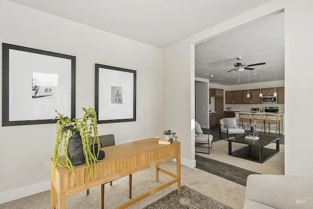 home office with ceiling fan and a textured ceiling