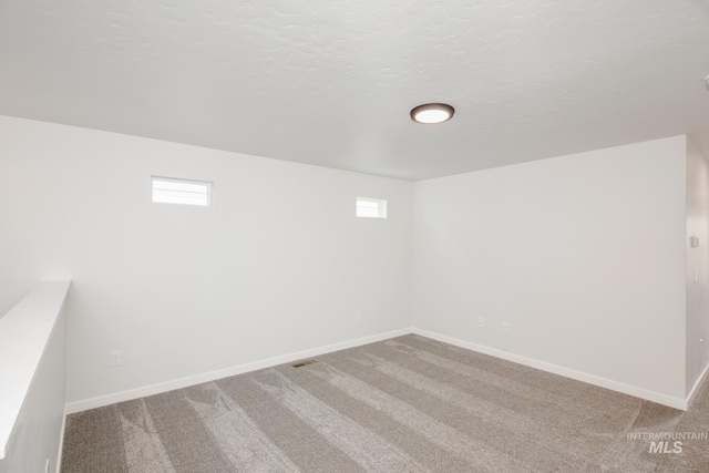 unfurnished room with light carpet