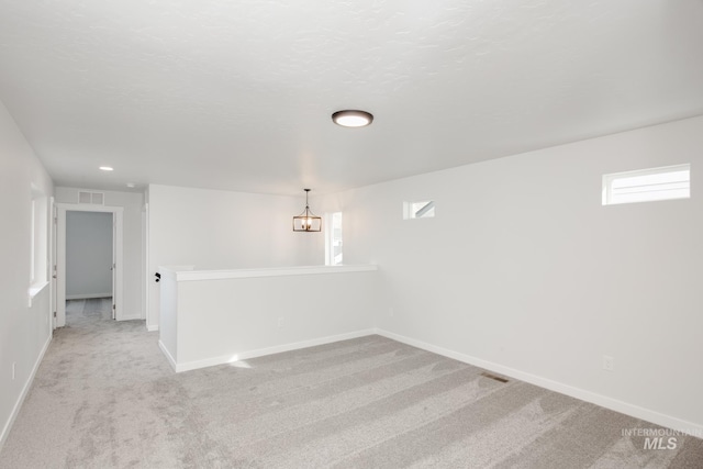 spare room with light colored carpet