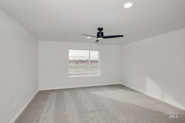 spare room with carpet and ceiling fan