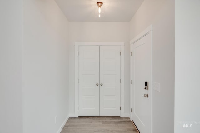 corridor with light hardwood / wood-style flooring