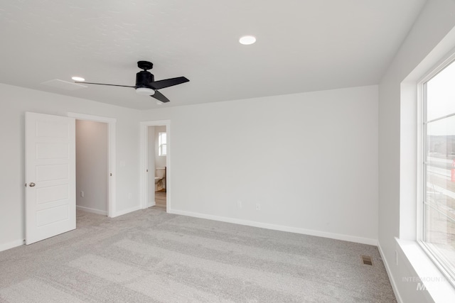 unfurnished room featuring plenty of natural light and light colored carpet