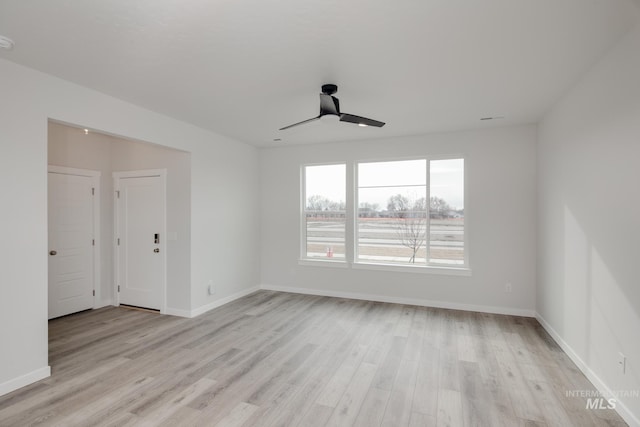 empty room with light hardwood / wood-style floors and ceiling fan