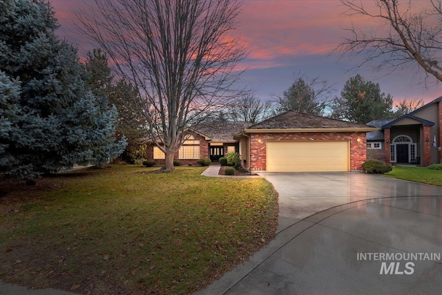 ranch-style home featuring a yard and a garage