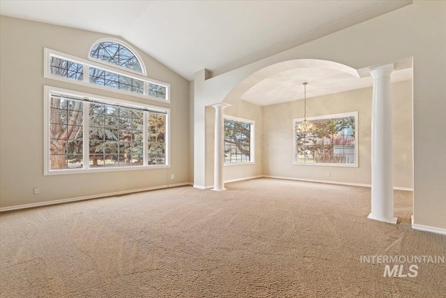 unfurnished living room with lofted ceiling, carpet floors, and a notable chandelier