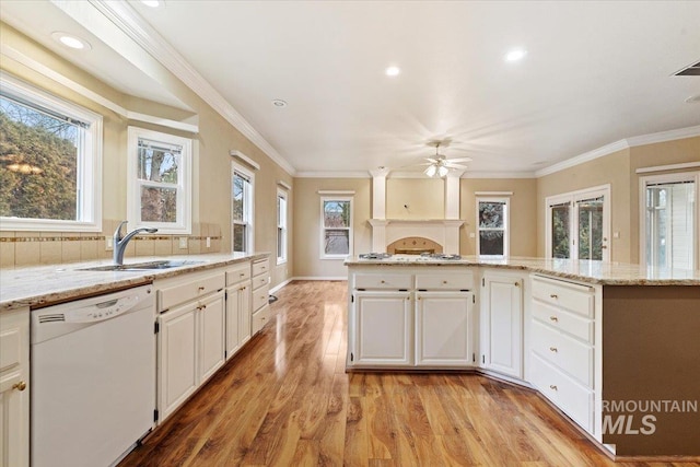 kitchen featuring white appliances, white cabinetry, light hardwood / wood-style floors, and light stone countertops