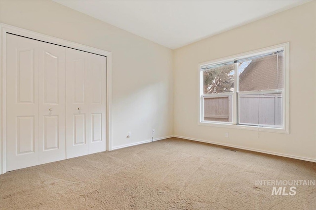 unfurnished bedroom with a closet and carpet flooring