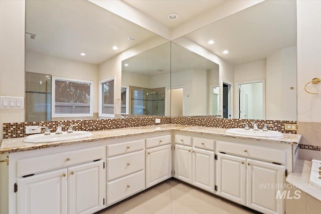 bathroom with tile patterned flooring, radiator heating unit, backsplash, an enclosed shower, and vanity