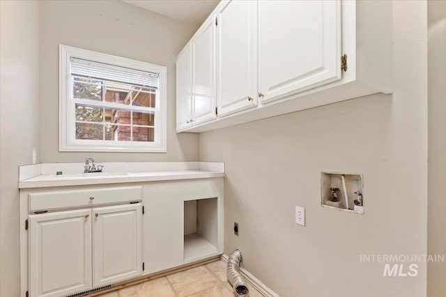 washroom with sink, cabinets, hookup for a washing machine, and hookup for an electric dryer