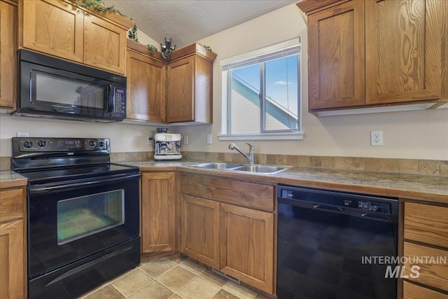 614 Ethan Ct, Jerome, ID 83338 - kitchen featuring black appliances, a sink, brown cabinetry, a textured ceiling, and light countertops