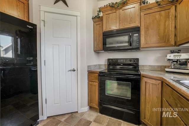 614 Ethan Ct, Jerome, ID 83338 - kitchen featuring black appliances, brown cabinetry, and tile counters