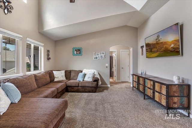 614 Ethan Ct, Jerome, ID 83338 - carpeted living room featuring arched walkways, high vaulted ceiling, and baseboards