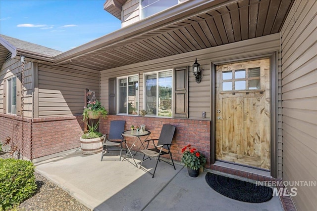 614 Ethan Ct, Jerome, ID 83338 - doorway to property with brick siding and a patio