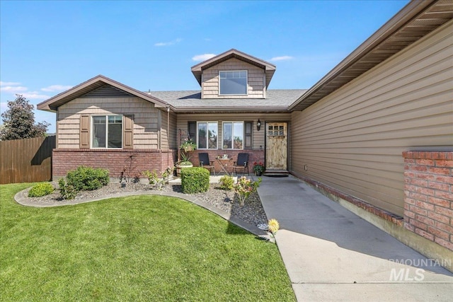 614 Ethan Ct, Jerome, ID 83338 - view of exterior entry featuring brick siding and a shingled roof