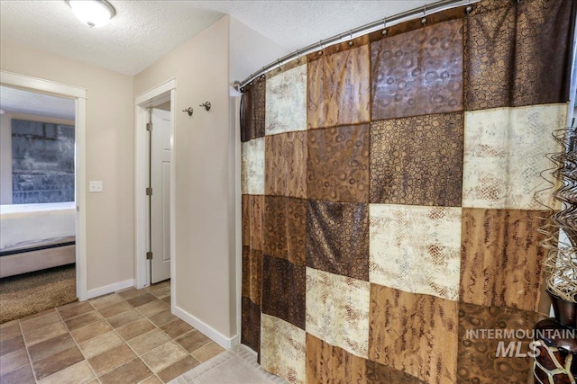 614 Ethan Ct, Jerome, ID 83338 - bathroom featuring baseboards, a textured ceiling, a baseboard heating unit, and a shower