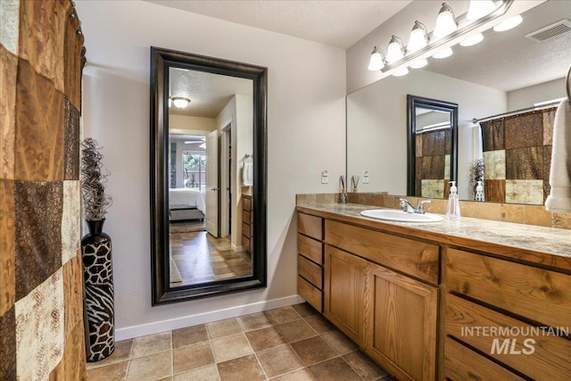 614 Ethan Ct, Jerome, ID 83338 - ensuite bathroom with vanity, baseboards, and a textured ceiling