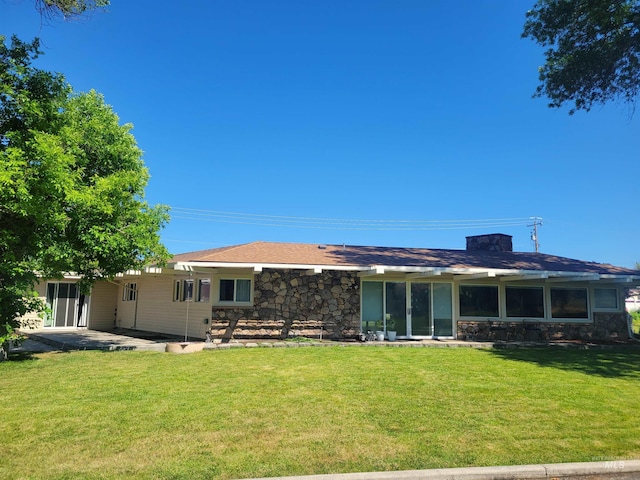 708 16th St, Clarkston, WA 99403 - rear view of property featuring stone siding, a lawn, and a patio area
