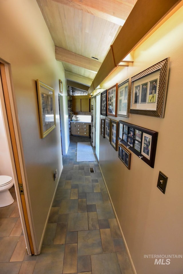 708 16th St, Clarkston, WA 99403 - hallway with stone finish floors and a wooden ceiling with exposed beams