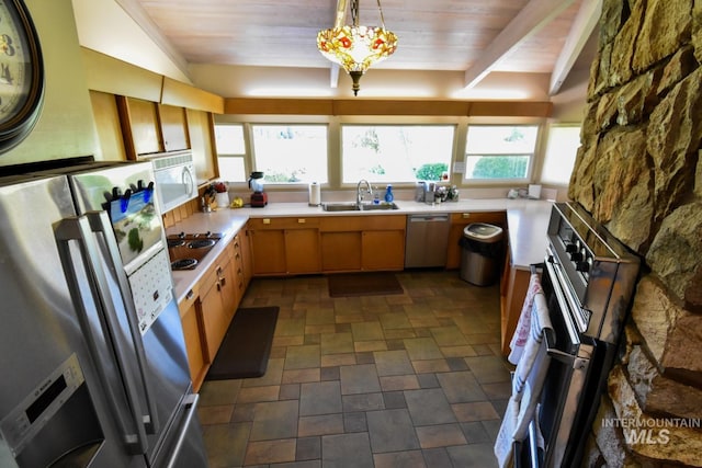 708 16th St, Clarkston, WA 99403 - kitchen with appliances with stainless steel finishes, light countertops, wood ceiling, stone finish floors, and pendant lighting