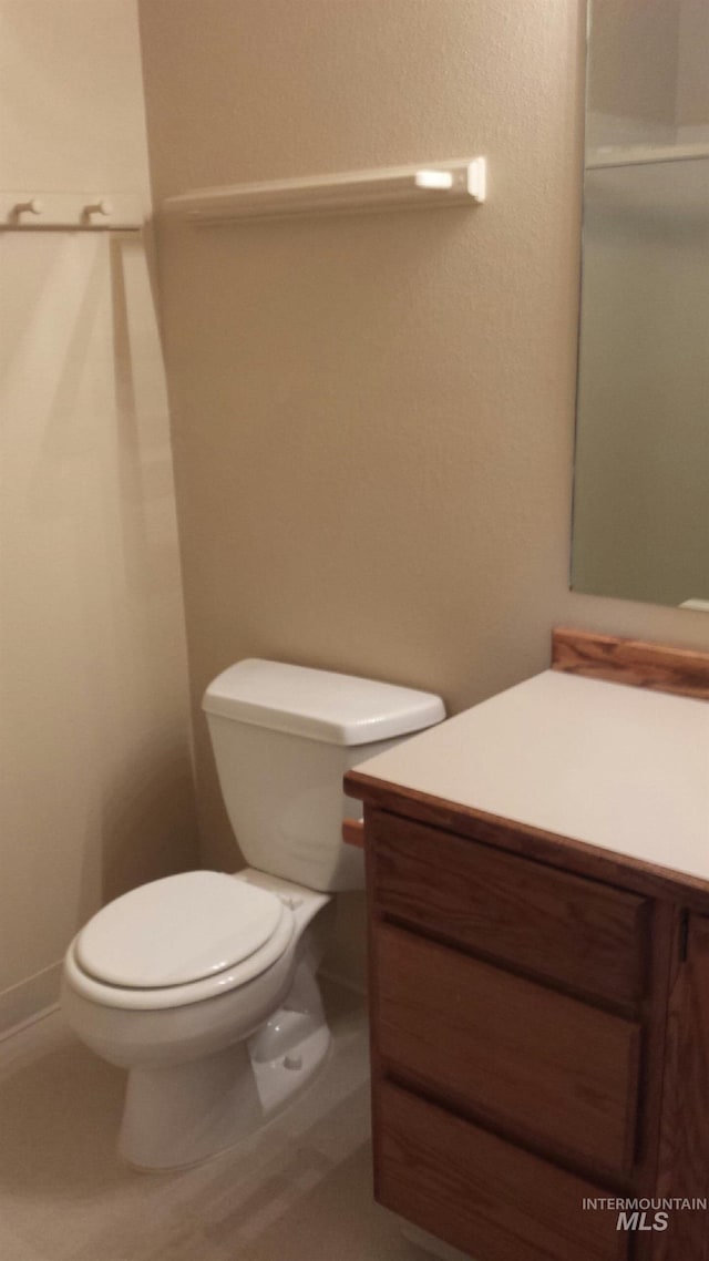 bathroom featuring toilet and vanity