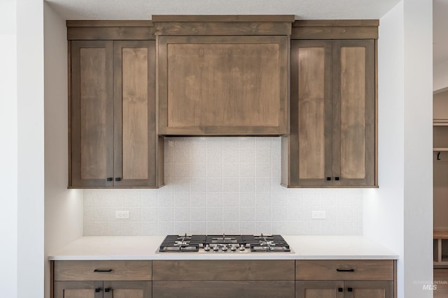 1246 E Rio Chico Dr, Kuna, ID 83634 - kitchen featuring stainless steel gas cooktop, light countertops, and decorative backsplash