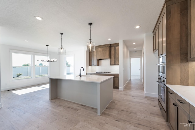 1246 E Rio Chico Dr, Kuna, ID 83634 - kitchen with a sink, light wood-type flooring, light countertops, gas stovetop, and recessed lighting