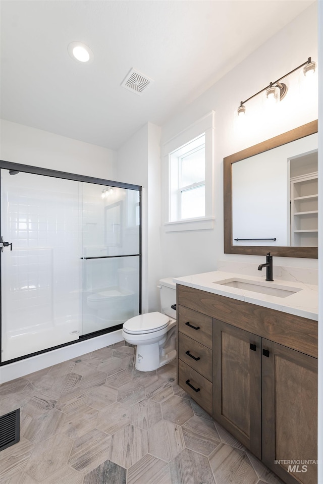 1246 E Rio Chico Dr, Kuna, ID 83634 - full bath featuring vanity, a shower stall, toilet, and recessed lighting