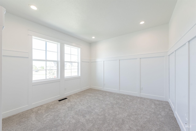 1246 E Rio Chico Dr, Kuna, ID 83634 - unfurnished room with a decorative wall, carpet floors, recessed lighting, and a wainscoted wall