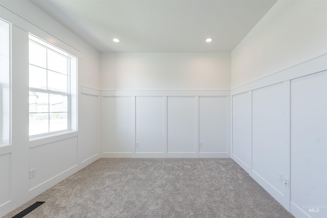 1246 E Rio Chico Dr, Kuna, ID 83634 - carpeted empty room with a decorative wall, a wainscoted wall, and recessed lighting