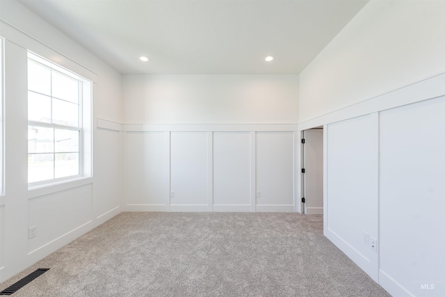 1246 E Rio Chico Dr, Kuna, ID 83634 - carpeted spare room with a decorative wall, wainscoting, and recessed lighting