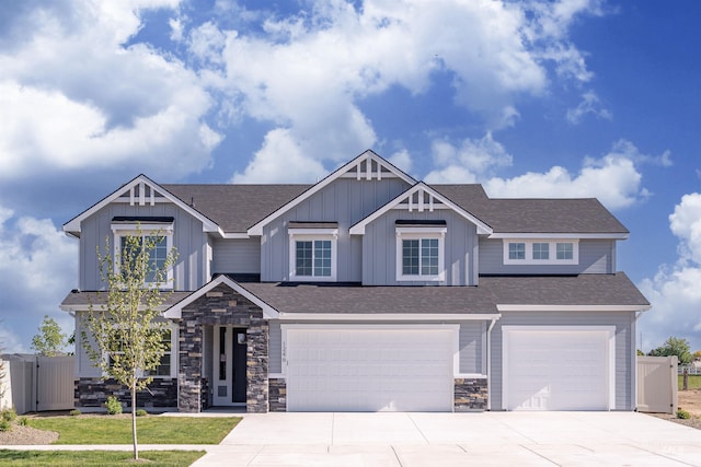 1246 E Rio Chico Dr, Kuna, ID 83634 - craftsman-style house featuring an attached garage, concrete driveway, board and batten siding, and stone siding