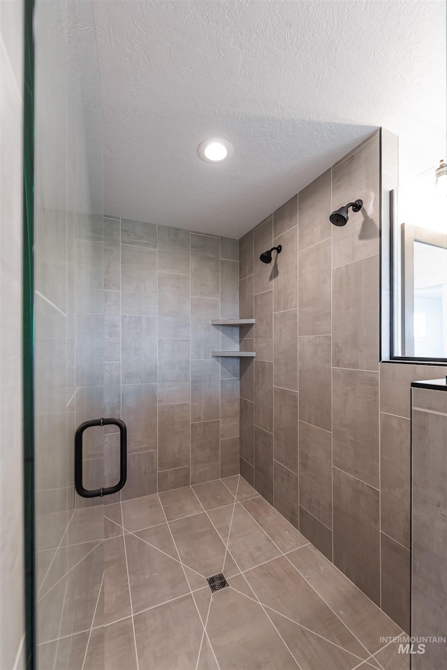 1246 E Rio Chico Dr, Kuna, ID 83634 - full bathroom with a shower stall, a textured ceiling, recessed lighting, and tile patterned floors