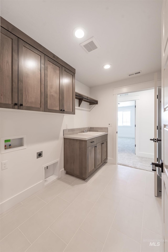1246 E Rio Chico Dr, Kuna, ID 83634 - laundry room with hookup for an electric dryer, cabinet space, hookup for a washing machine, recessed lighting, and baseboards