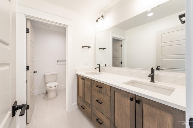 1246 E Rio Chico Dr, Kuna, ID 83634 - bathroom featuring double vanity, tile patterned flooring, toilet, and baseboards