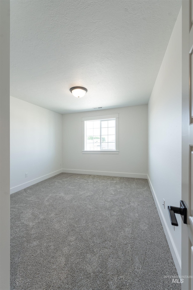 1246 E Rio Chico Dr, Kuna, ID 83634 - unfurnished room with carpet floors, baseboards, and a textured ceiling