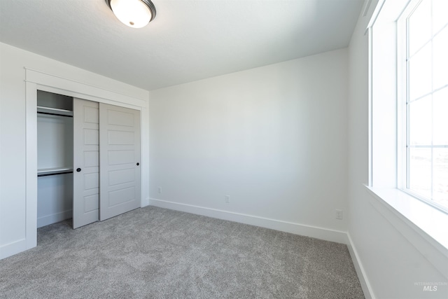 1246 E Rio Chico Dr, Kuna, ID 83634 - unfurnished bedroom with carpet floors, baseboards, and a closet