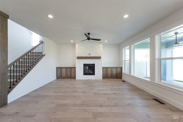 1246 E Rio Chico Dr, Kuna, ID 83634 - unfurnished living room with a ceiling fan, recessed lighting, light wood-style floors, baseboards, and stairs