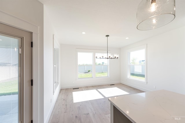 1246 E Rio Chico Dr, Kuna, ID 83634 - unfurnished dining area featuring light wood-style flooring, a chandelier, baseboards, and recessed lighting