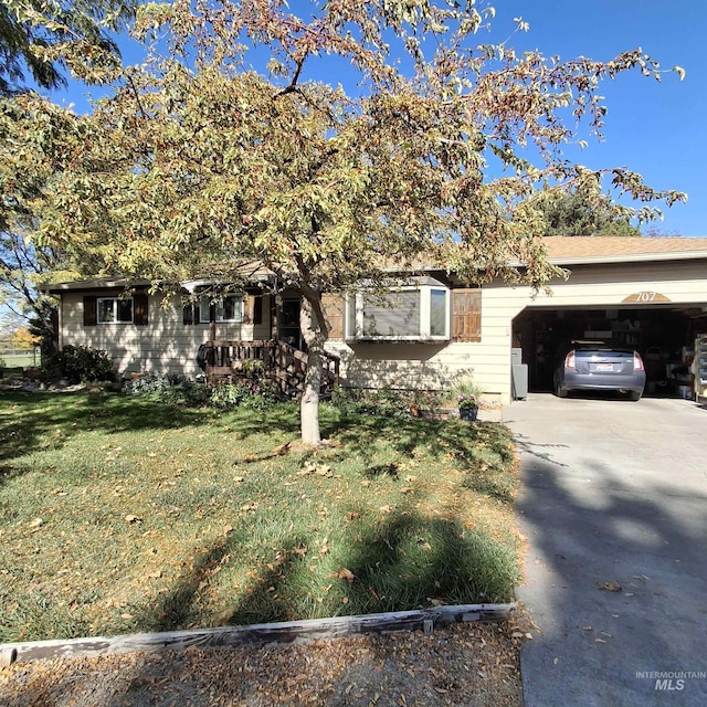 obstructed view of property with a garage and a front yard