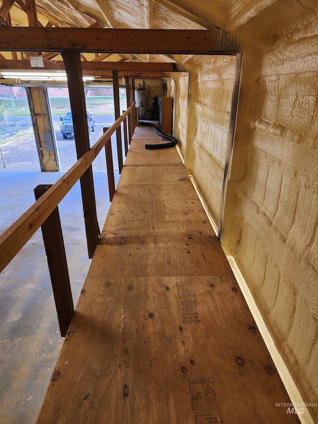 corridor with lofted ceiling and a healthy amount of sunlight