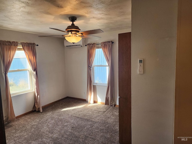 carpeted empty room featuring ceiling fan, an AC wall unit, and a textured ceiling