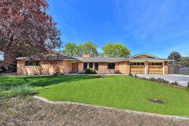 204 Hilldrop St, Caldwell, ID 83605 - ranch-style house featuring driveway, a chimney, a garage, brick siding, and a front yard