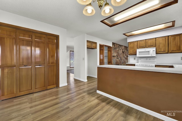 204 Hilldrop St, Caldwell, ID 83605 - kitchen featuring light wood-type flooring, light countertops, white appliances, and brown cabinets