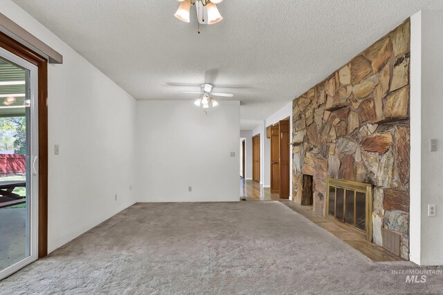 204 Hilldrop St, Caldwell, ID 83605 - unfurnished living room featuring ceiling fan, carpet flooring, a textured ceiling, and a fireplace