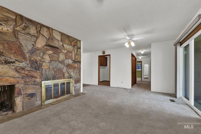 204 Hilldrop St, Caldwell, ID 83605 - unfurnished living room with a textured ceiling, ceiling fan, light carpet, a fireplace, and visible vents