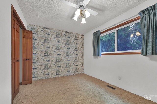 204 Hilldrop St, Caldwell, ID 83605 - spare room featuring ceiling fan, light carpet, a textured ceiling, and visible vents