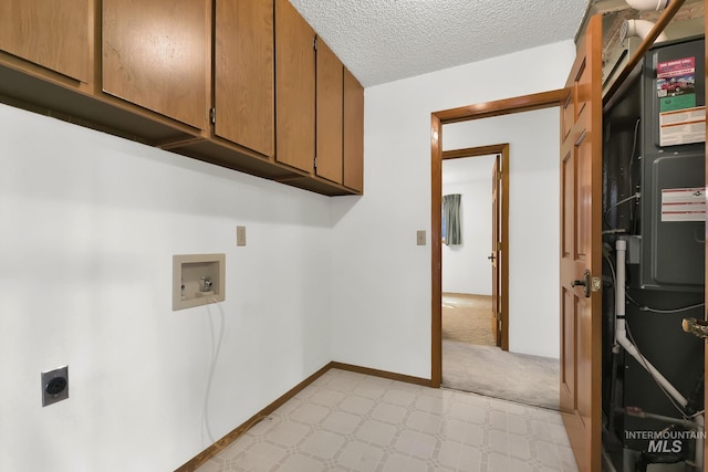 204 Hilldrop St, Caldwell, ID 83605 - clothes washing area with a textured ceiling, hookup for an electric dryer, washer hookup, cabinet space, and light floors