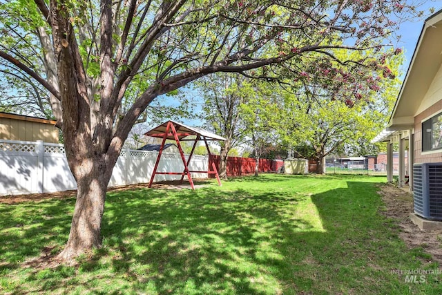 204 Hilldrop St, Caldwell, ID 83605 - view of yard with central AC, a fenced backyard, and a playground